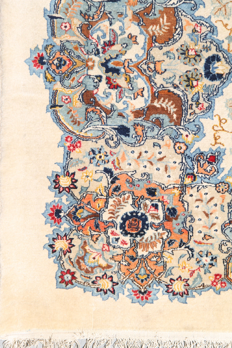 Image Alt Text: Antique semi-antique Kerman wool rug in blue and ivory with European floral design