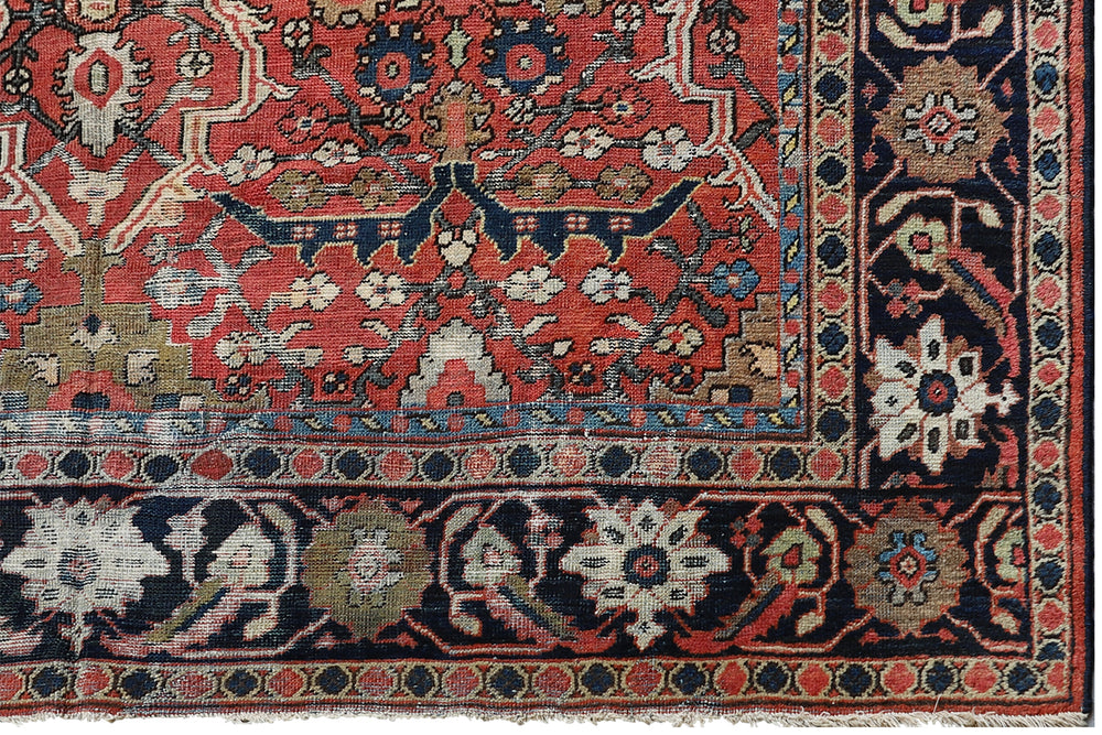 9x12 antique Persian Mahal rug with terracotta rust ground, navy blue geometric border, and ivory details