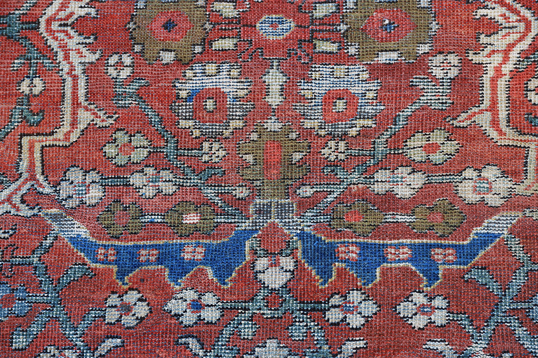 9x12 antique Persian Mahal rug with terracotta rust ground, navy blue geometric border, and ivory details