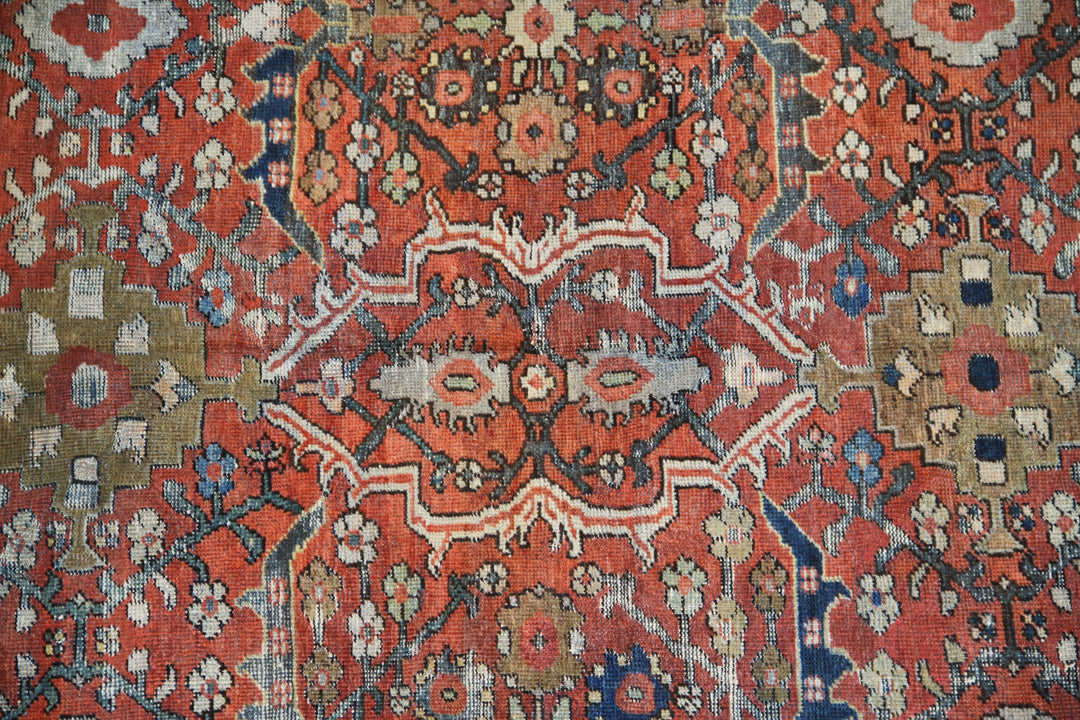 9x12 antique Persian Mahal rug with terracotta rust ground, navy blue geometric border, and ivory details