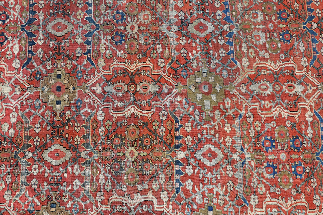 9x12 antique Persian Mahal rug with terracotta rust ground, navy blue geometric border, and ivory details