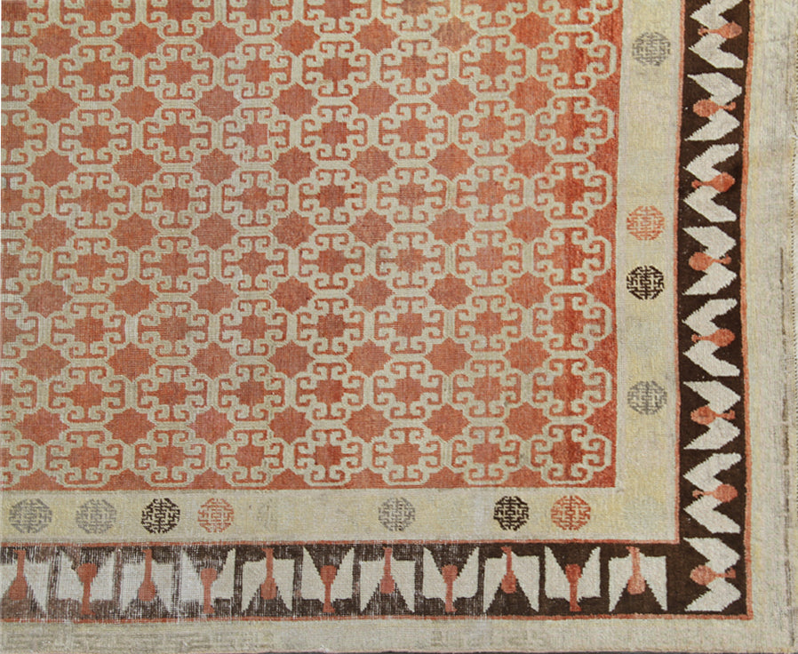 Antique Samarkand hand-knotted wool rug measuring 8'9" x 5'4" featuring a bold geometric design in red, dark brown, and ivory tones.