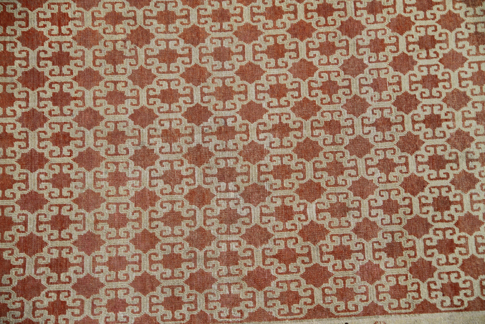 Antique Samarkand hand-knotted wool rug measuring 8'9" x 5'4" featuring a bold geometric design in red, dark brown, and ivory tones.