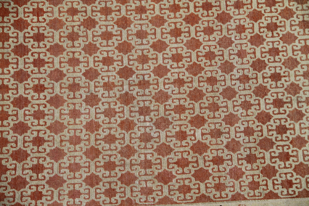 Antique Samarkand hand-knotted wool rug measuring 8'9" x 5'4" featuring a bold geometric design in red, dark brown, and ivory tones.