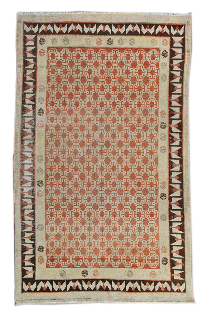 Antique Samarkand hand-knotted wool rug measuring 8'9" x 5'4" featuring a bold geometric design in red, dark brown, and ivory tones.