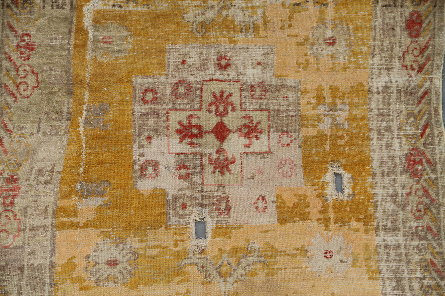 Authentic antique hand-knotted Samarkand Khotan wool area rug in rich gold and orange tones with low pile distressed character