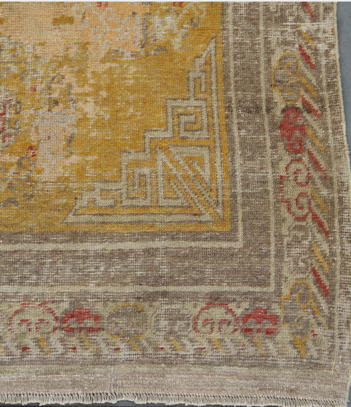 Authentic antique hand-knotted Samarkand Khotan wool area rug in rich gold and orange tones with low pile distressed character