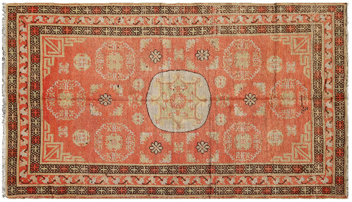 Authentic antique hand-knotted Samarkand Khotan wool area rug featuring bold black and grey geometric medallions on a vibrant orange field