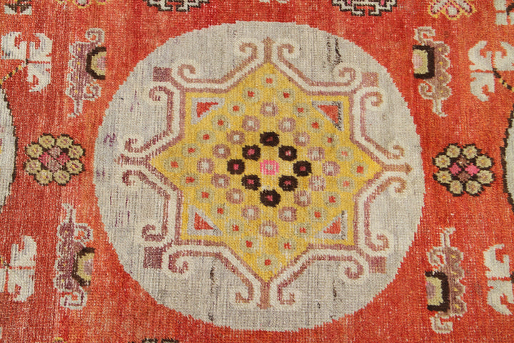 Authentic antique hand-knotted Samarkand Khotan wool area rug featuring three classic medallions in aqua and neutral tones on a rich orange-red field
