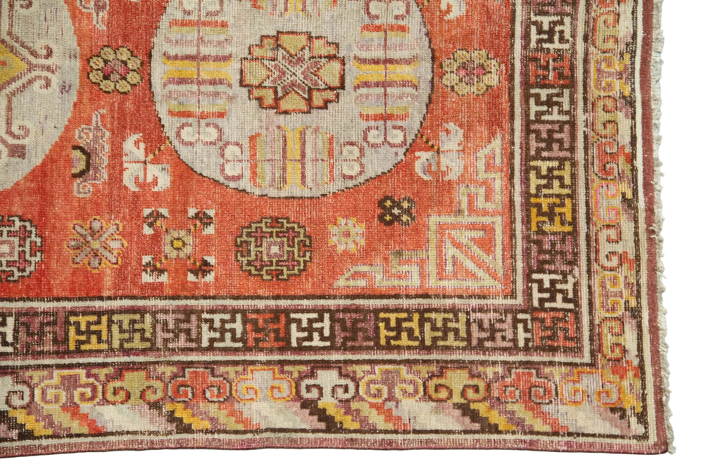 Authentic antique hand-knotted Samarkand Khotan wool area rug featuring three classic medallions in aqua and neutral tones on a rich orange-red field