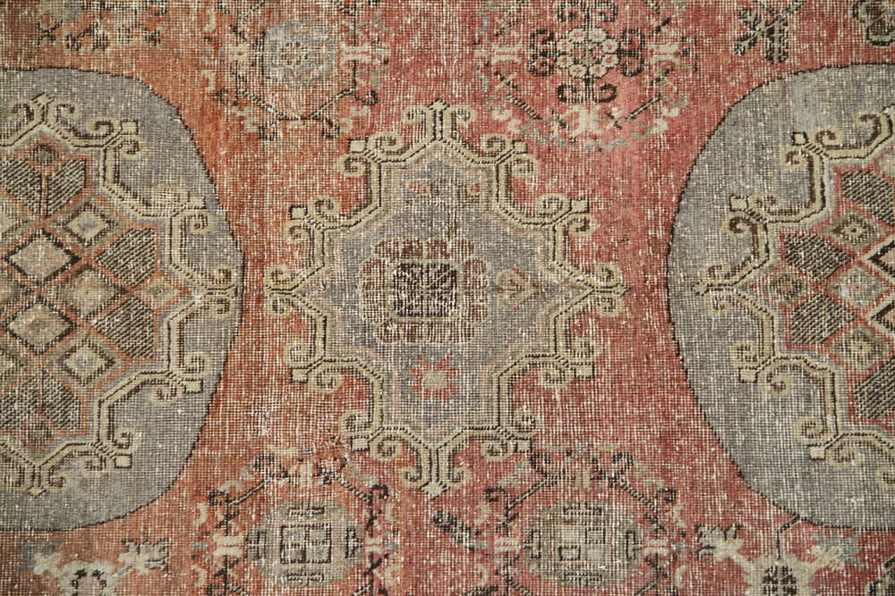 Authentic antique hand-knotted Samarkand Khotan wool area rug featuring classic medallions on a rich orange-red field with brown and cream accents