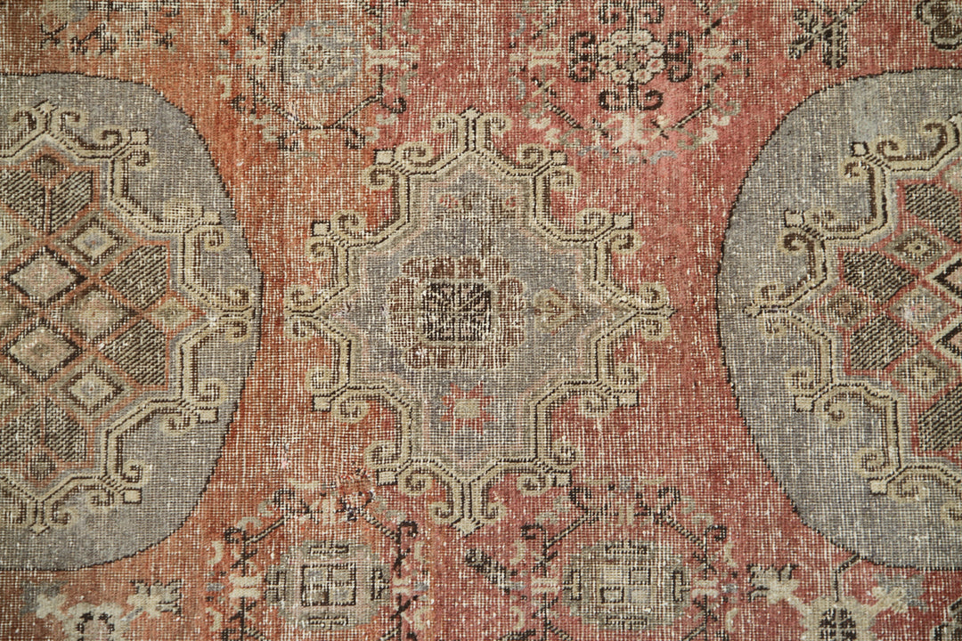 Authentic antique hand-knotted Samarkand Khotan wool area rug featuring classic medallions on a rich orange-red field with brown and cream accents