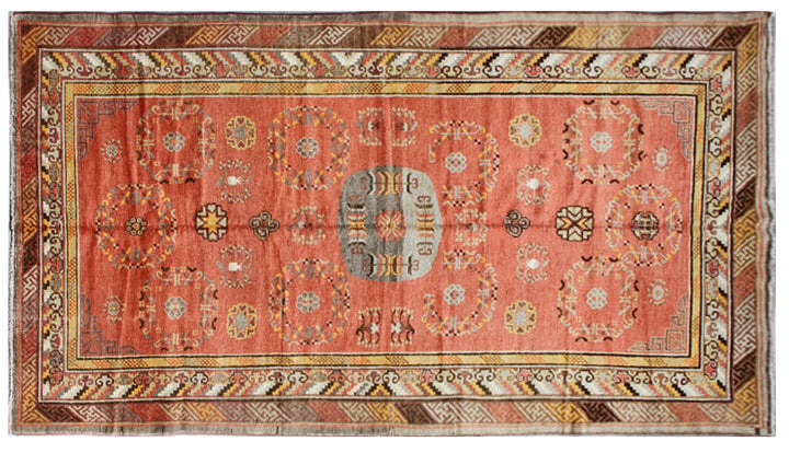 Authentic 2nd quarter 20th century hand-knotted Samarkand Khotan wool rug featuring an orange field with red pink beige botanical medallions