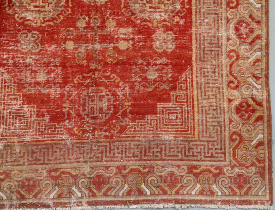 Authentic antique hand-knotted Samarkand Khotan wool area rug featuring classic medallions in grey and soft tan on a rich red field