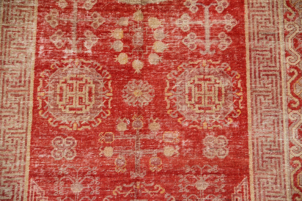 Authentic antique hand-knotted Samarkand Khotan wool area rug featuring classic medallions in grey and soft tan on a rich red field