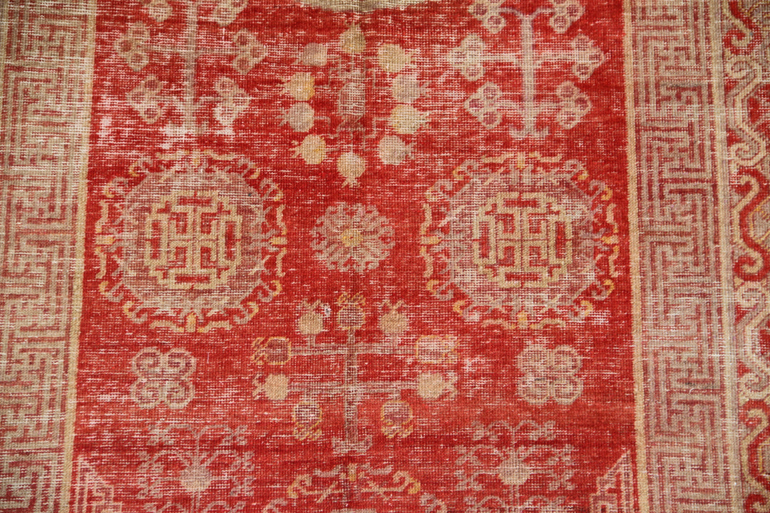 Authentic antique hand-knotted Samarkand Khotan wool area rug featuring classic medallions in grey and soft tan on a rich red field