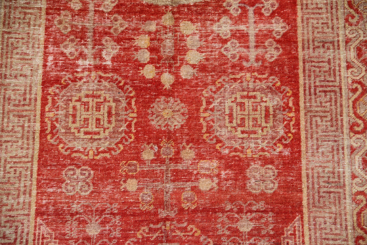 Authentic antique hand-knotted Samarkand Khotan wool area rug featuring classic medallions in grey and soft tan on a rich red field
