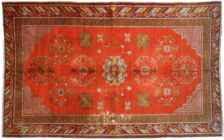 Authentic antique hand-knotted Samarkand Khotan wool area rug featuring a central medallion on a rich red field