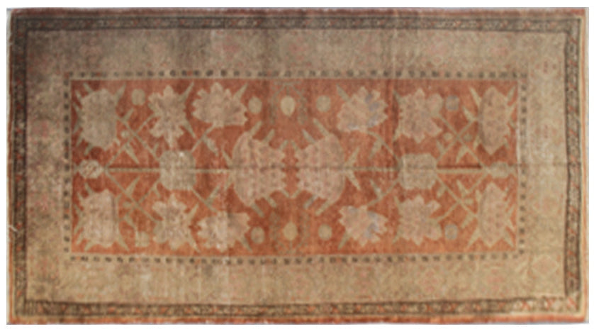 Authentic antique hand-knotted Samarkand Khotan wool area rug featuring salmon pink floral motifs on a warm rust field