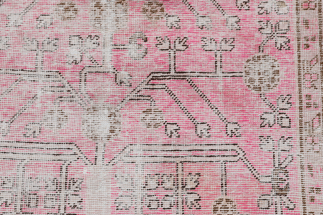 Antique Samarkand Khotan wool rug measuring 5'2" x 4'0" featuring a delicate pink floral design and vintage patina.