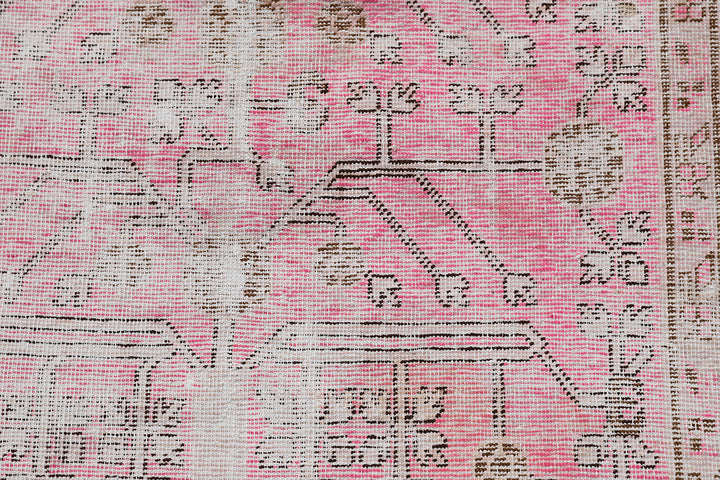 Antique Samarkand Khotan wool rug measuring 5'2" x 4'0" featuring a delicate pink floral design and vintage patina.