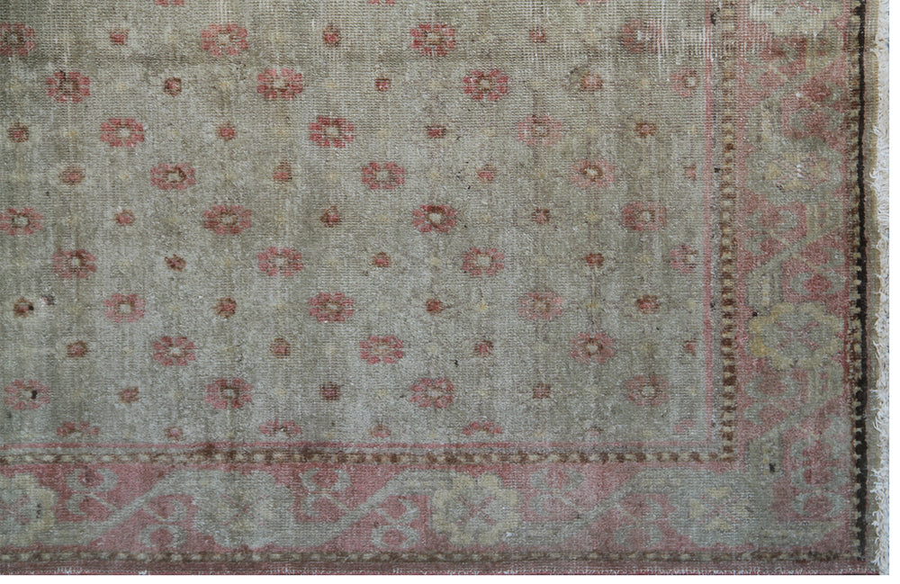 Rare 4x7 antique Samarkand hand-knotted wool rug featuring pink terracotta flowers on a soft green background by Ariana Rugs.