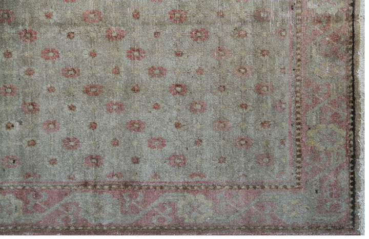 Rare 4x7 antique Samarkand hand-knotted wool rug featuring pink terracotta flowers on a soft green background by Ariana Rugs.