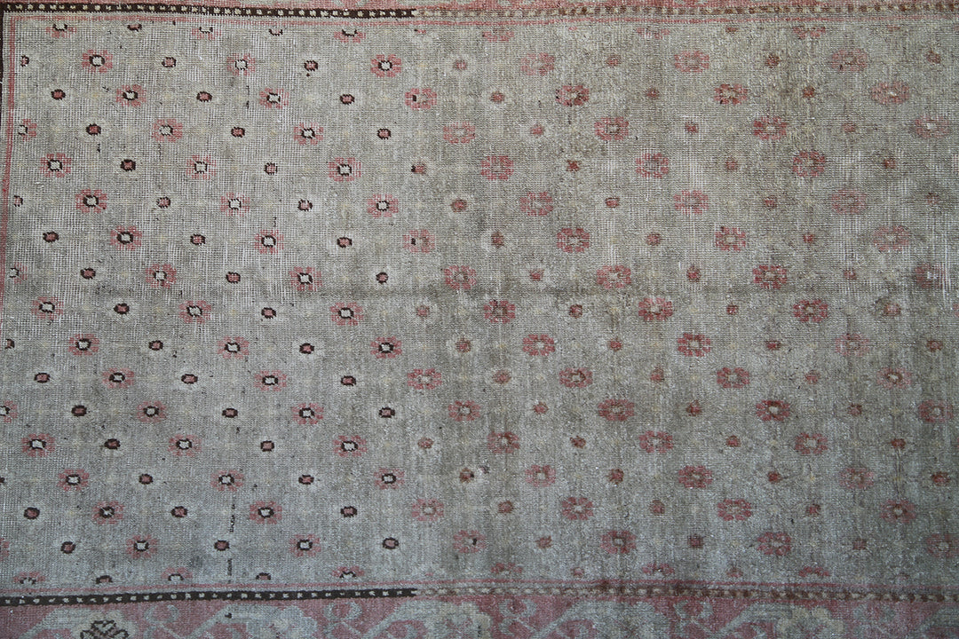 Rare 4x7 antique Samarkand hand-knotted wool rug featuring pink terracotta flowers on a soft green background by Ariana Rugs.