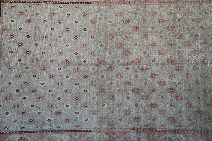 Rare 4x7 antique Samarkand hand-knotted wool rug featuring pink terracotta flowers on a soft green background by Ariana Rugs.