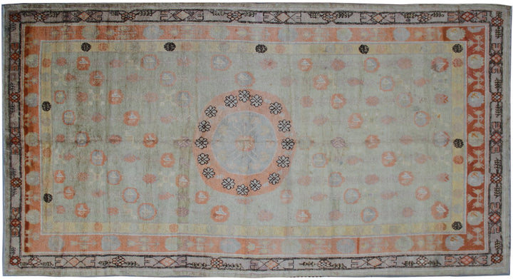 Rare 4x13 antique Samarkand hand-knotted wool gallery runner rug featuring orange medallions on a soft grey background by Ariana Rugs.