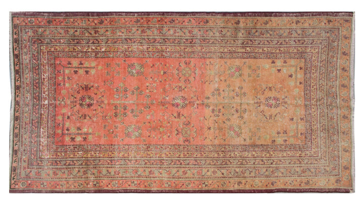 Authentic 5x8 antique Samarkand hand-knotted wool area rug featuring an all-over soft terracotta medallion design on a washed-out red field by Ariana Rugs.