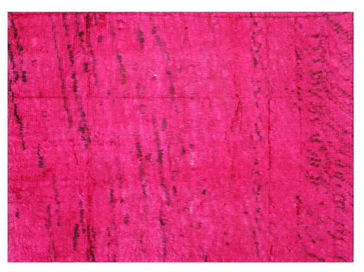 A hot pink, hand-knotted, shaggy rug with a textured surface, part of the Ariana Barchi Collection.