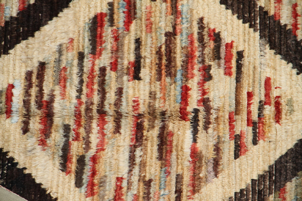 Hand-crafted 9'3" x 6'3" Moroccan Barchi wool area rug featuring a brown geometric diamond pattern over a vibrant striped background with plush long pile.