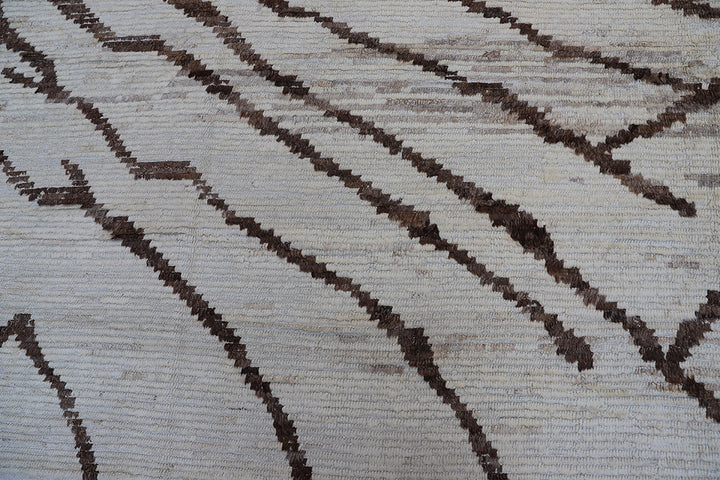 Hand-crafted 15'5" x 12'7" oversized Moroccan-style shag wool on cotton area rug featuring a brown and ivory zebra pattern from the Ariana Barchi Collection.
