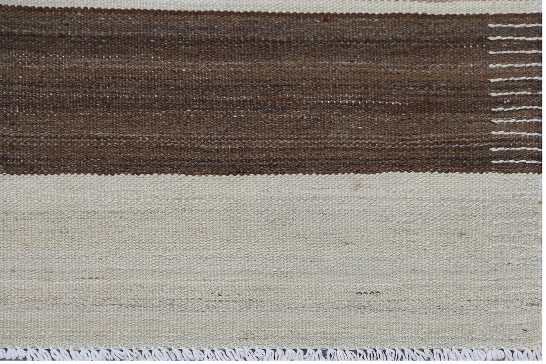 6x9 Ariana Kilim hand-woven Afghan wool rug with brown, beige, and cream stripes, full overhead view.