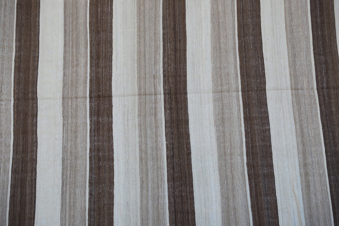 6x9 Ariana Kilim hand-woven Afghan wool rug with brown, beige, and cream stripes, full overhead view.