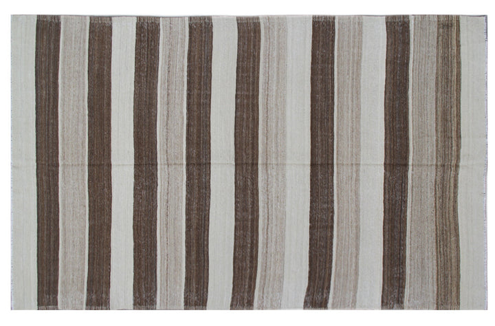 Organic modern sitting room styled with a 6x10 earth-tone brown, tan, and cream striped Afghan wool kilim from Ariana Rugs West Hollywood.