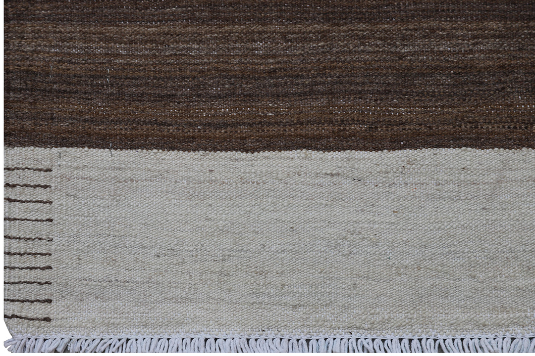 Close-up of organic hand-spun wool weave showing wide ivory and brown striped detail on Afghan kilim by Hazara weavers.