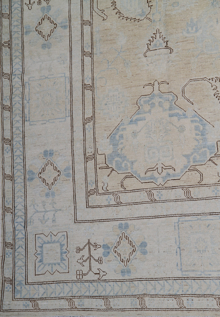 Ariana large Caucasian design wool rug in ivory and pale blue, hand-knotted in Afghanistan by Hazara artisans. Luxury oversized geometric area rug for elegant interiors.