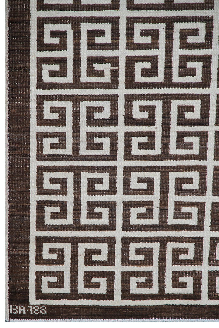 Close-up of 6'x9' Ariana Modern rug showing ivory white geometric lines on a dark brown background.
