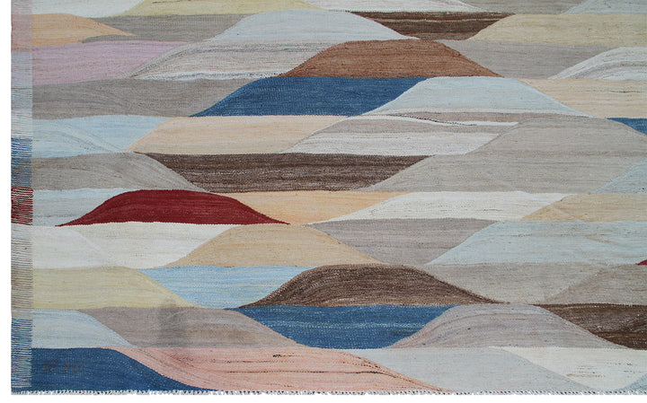 Ariana Rugs 14'x22' extra large handwoven colorful wool kilim area rug featuring a geometric pattern in blue, cream, rust, and brown on a cotton foundation.