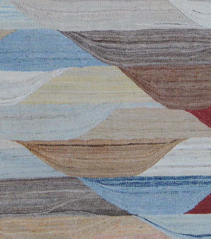 Ariana Rugs 14'x22' extra large handwoven colorful wool kilim area rug featuring a geometric pattern in blue, cream, rust, and brown on a cotton foundation.