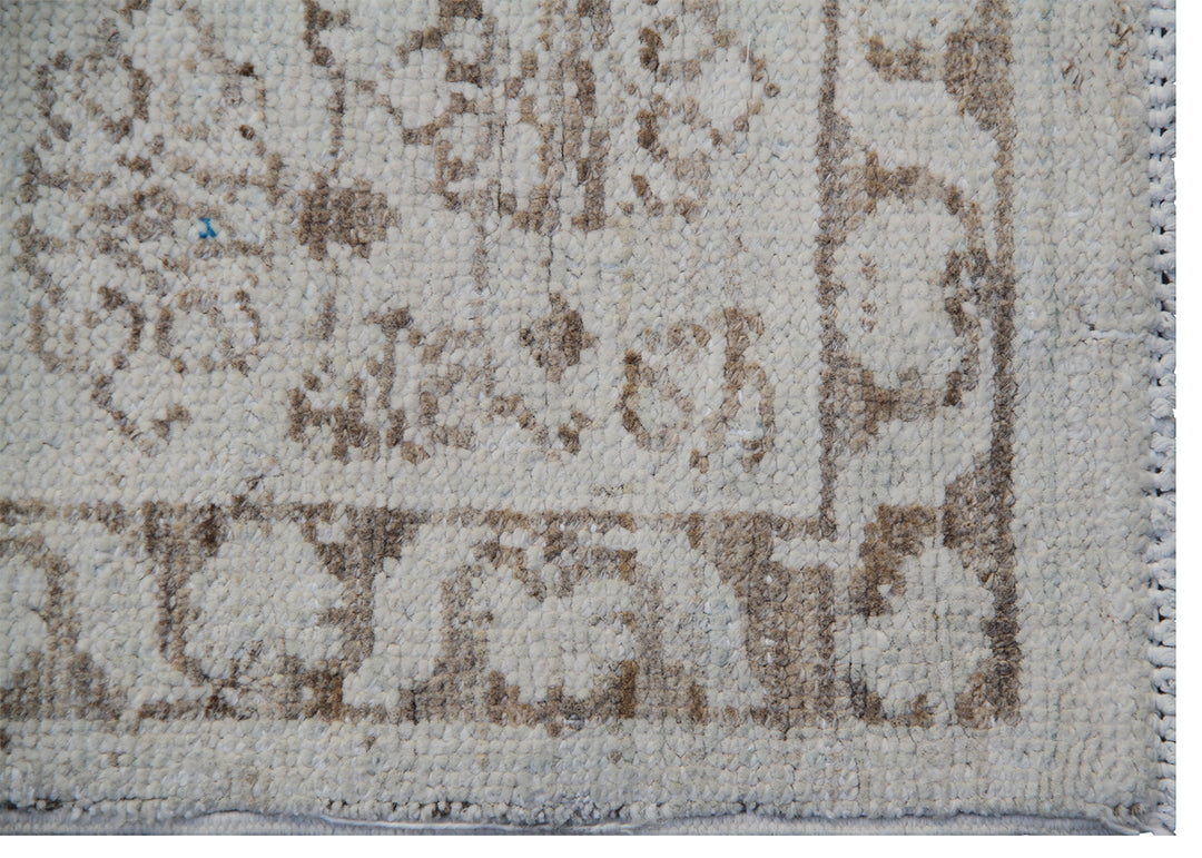 Ariana Samarkand collection 5'x4' hand-knotted wool area rug in beige and brown featuring a geometric design