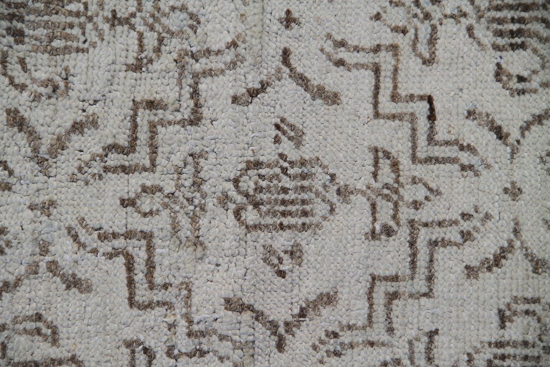 Ariana Samarkand collection 5'x4' hand-knotted wool area rug in beige and brown featuring a geometric design
