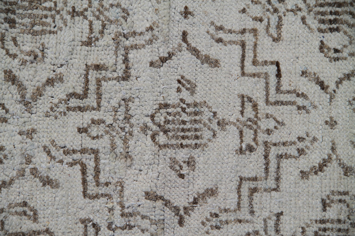 Ariana Samarkand collection 5'x4' hand-knotted wool area rug in beige and brown featuring a geometric design