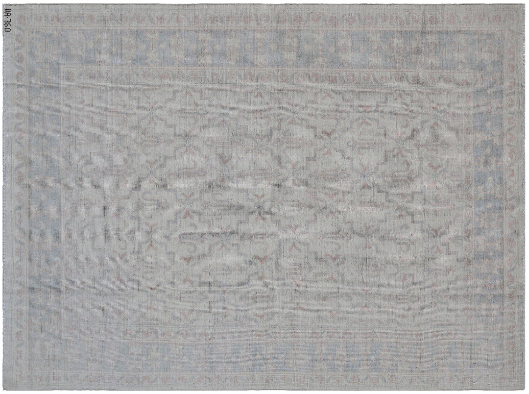 Authentic Ariana Transitional Collection 5x7 wool area rug featuring an ivory and cream geometric pattern with blue accents, ethically hand-knotted in Afghanistan.