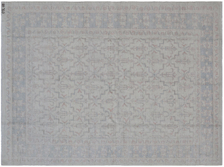 Authentic Ariana Transitional Collection 5x7 wool area rug featuring an ivory and cream geometric pattern with blue accents, ethically hand-knotted in Afghanistan.