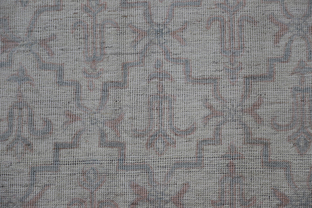 Authentic Ariana Transitional Collection 5x7 wool area rug featuring an ivory and cream geometric pattern with blue accents, ethically hand-knotted in Afghanistan.