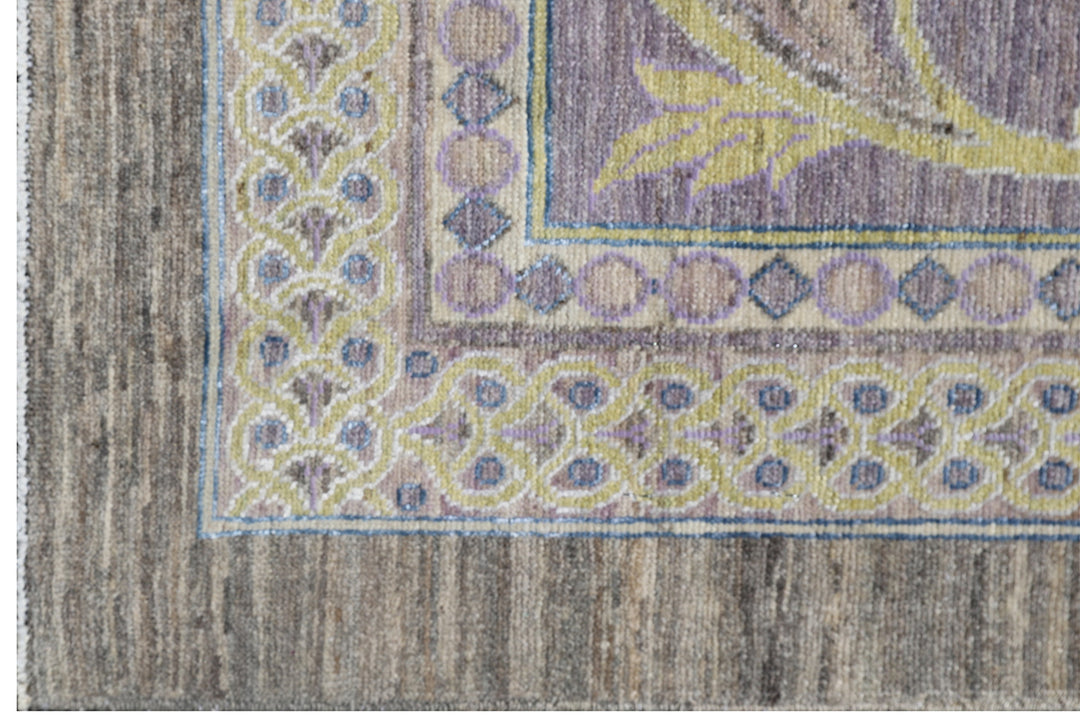 Authentic hand-knotted oversized Ariana Transitional wool area rug featuring a subtle purple, luminous yellow, and ivory palette
