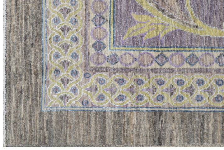 Authentic hand-knotted oversized Ariana Transitional wool area rug featuring a subtle purple, luminous yellow, and ivory palette